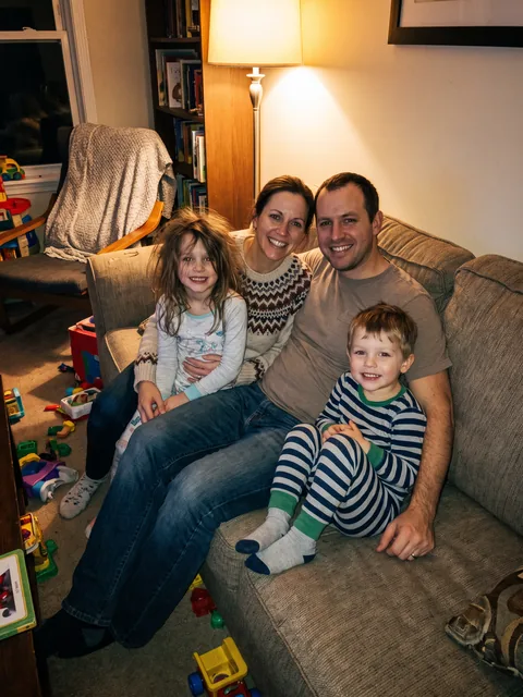 A family of four on a sofa, a casual phone photo