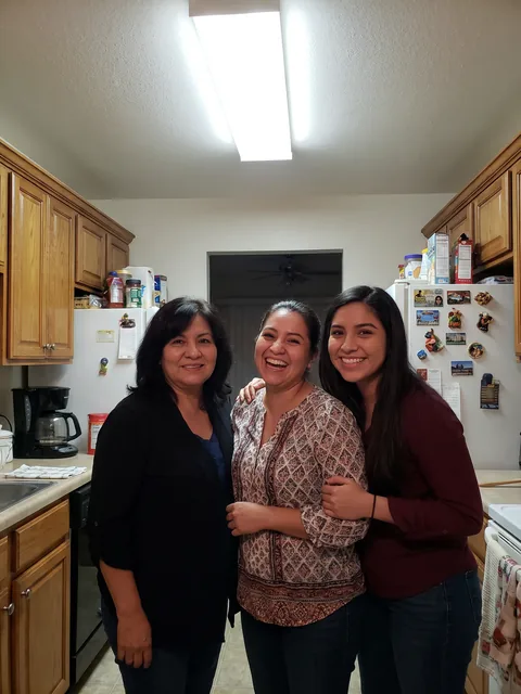 A mother and her two daughters in a kitchen